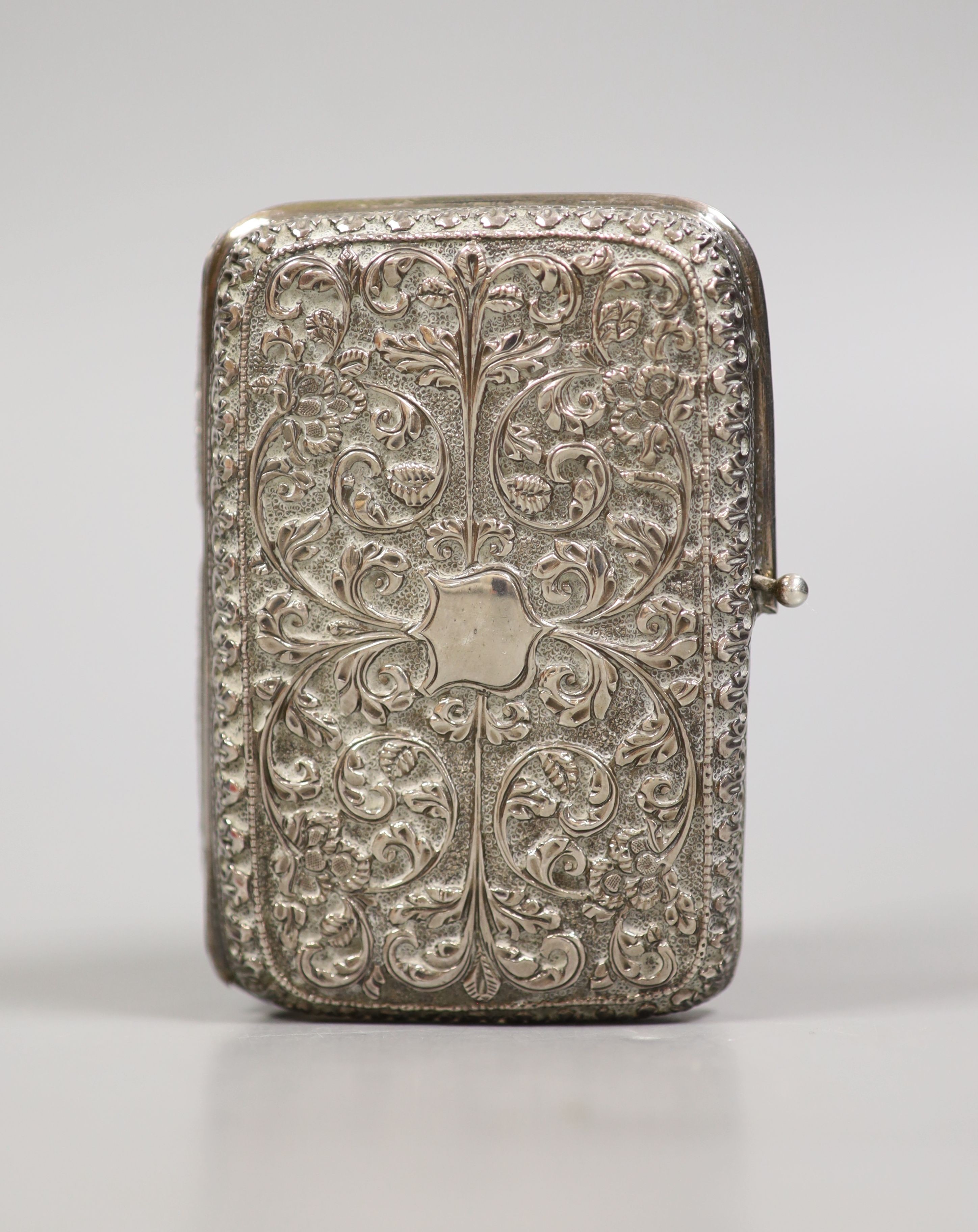 A Persian embossed white metal cigarette case (a.f.), 97mm, 117 grams.